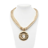 Collana in corda bianca e oro con pendaglio.