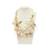 Collana oro e bianco con applicazioni marine.