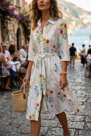 Abito camicia in fantasia fondo bianco.