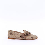 Slippers with print and rhinestone bow.